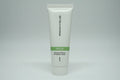 Studio lighting detail shot of Rodan + Fields SOOTHE travel cleanser tube with green accent band