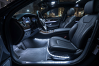 Car interior at night with four pairs of cool white LED flex strip lights glowing in footwells and under seats