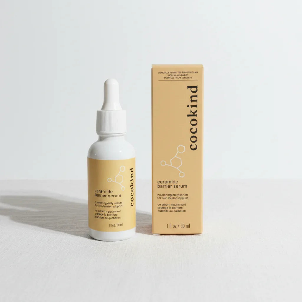 Minimalist Cocokind Ceramide Barrier Serum white dropper bottle and gold box on white linen surface, bright even lighting, clean label skincare