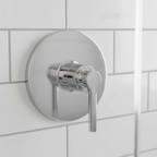 American Standard Studio S polished chrome pressure balance valve trim installed on a white subway tile shower wall.
