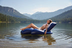 Intex Floating Recliner Lounge woman sunbathing on calm mountain lake pine trees sunny summer day