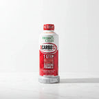 Herbal Clean QCarbo32 large white and red supplement drink bottle on clean white marble surface, soft natural light