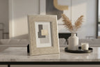 Modern home decor layout featuring metallic textured decorative picture frame on neutral surface