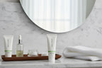 Clean modern bathroom setup with travel-sized Rodan + Fields SOOTHE Calming Gel Cleanser on marble surface