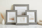 Modern home styling with distressed-look weathered grey decorative frames on a clean vanity surface