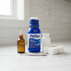 Balanced aesthetic of blue digestive health medicine bottle set in home health storage arrangement on neutral white marble counter
