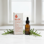 Bio-Oil Skincare Oil box beside amber dropper bottle and fresh rosemary sprigs on white marble countertop – More4less Outlet