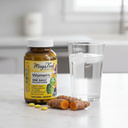 Women's multivitamin amber glass bottle beside water glass and fresh turmeric root on white marble countertop – More4less Outlet