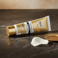 RoC Retinol Correxion Deep Wrinkle Night Cream gold tube on dark marble with rose petal and gold dish.