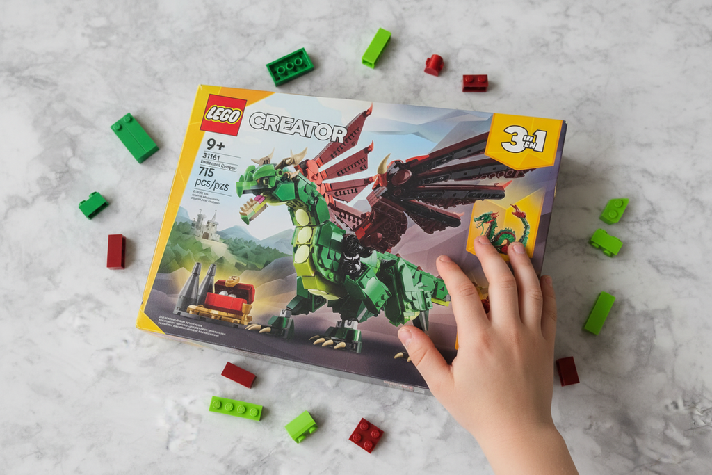 LEGO Creator 31161 Medieval Dragon box flat lay on marble surface with loose green and red bricks