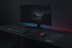 Clean minimalist dark gaming workstation with Corsair Raptor M3 mouse on ROCCAT Kanga mousepad alongside mechanical keyboard and monitor
