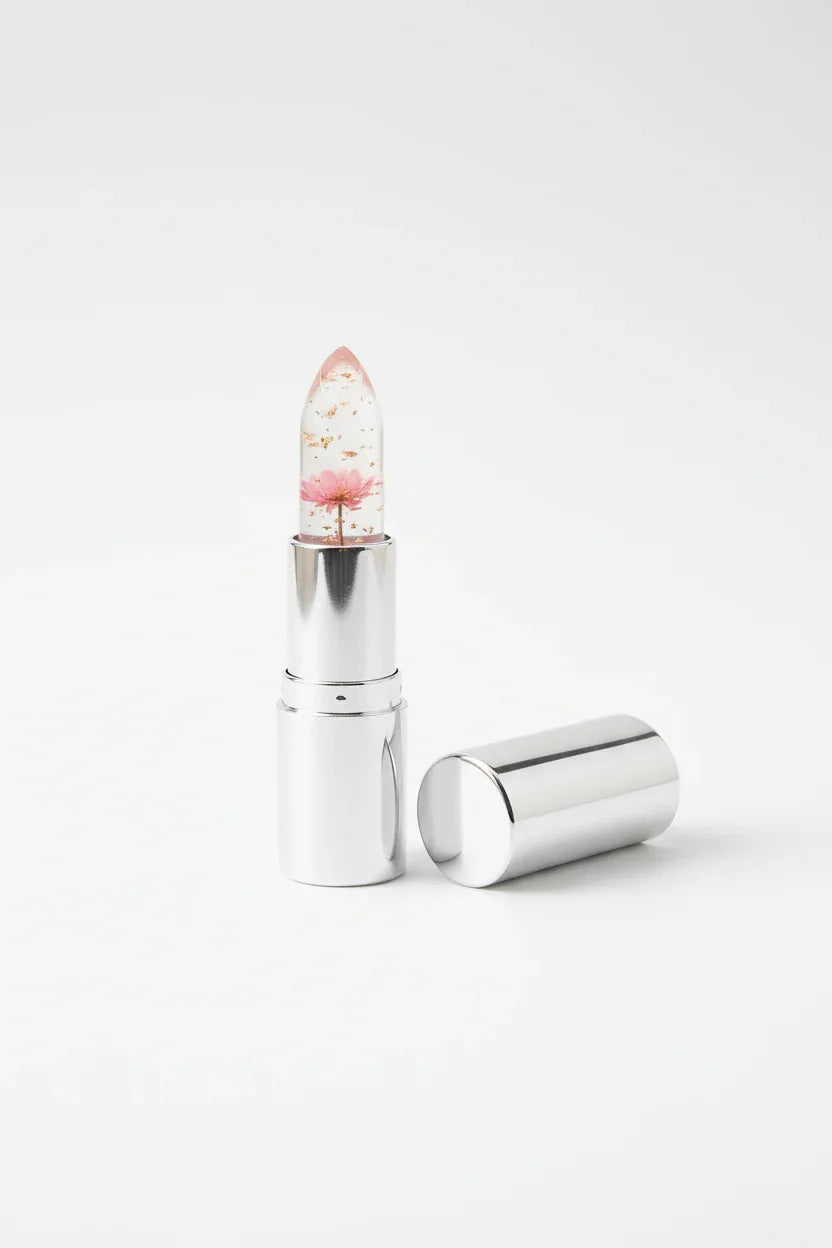 Single Firstfly Gold Foil Flowers color-changing lipstick on white studio background highlighting transparency and foil flakes