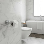 Luxury modern bathroom with Delta Trinsic polished chrome wall-mounted toilet paper holder on white marble tile