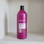 Redken Color Extend Magnetics Conditioner 33.8 fl oz / 1 L bottle on a neutral bathroom shelf