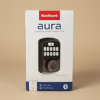 Kwikset Aura Bluetooth keypad smart lock in its original retail box in a neutral setting