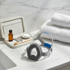 AI-generated contextual bathroom counter image of ResMed AirTouch N20 nasal mask with towels.