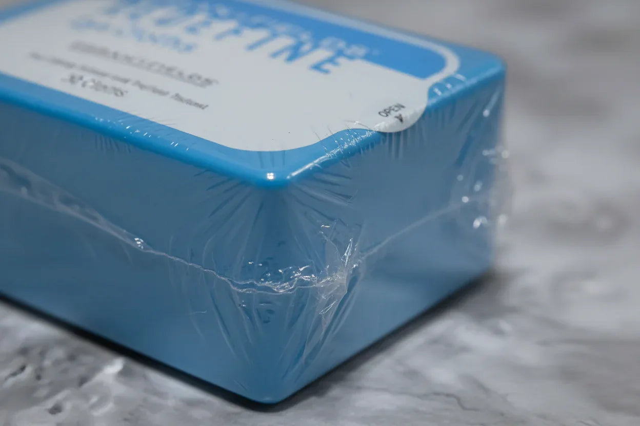 Macro detail of sealed wrap on Rodan + Fields 30-count cosmetic cleansing cloths package