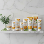Spa bathroom shelf with organic and vegan skincare products in white and orange tones on marble