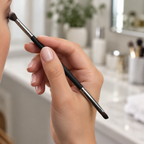 AI-generated lifestyle photo of a hand applying eyeshadow with the Mary Kay Dual-Ended Eye Definer and Eye Crease Brush