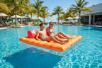 Cheez-It Giant Pool Float two friends lounging tropical resort pool palm trees