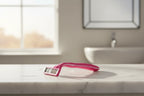 Bright morning sunlight hitting a fresh pink women's razor on a clean white marble bathroom shelf