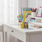 Disney Encanto micro journal with 4 secret micro surprises displayed on child's white desk in bright sunlight.