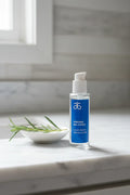 Arbonne Bio-Hydria Liquid Serum on bright bathroom vanity with natural light skincare lifestyle