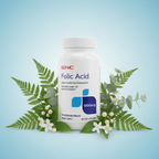 GNC Folic Acid 1000mcg bottle sky blue editorial with botanical leaves and white flower accents – More4less Outlet