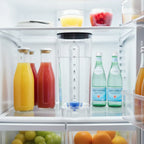 Ninja Thirsti 48oz water reservoir filled with clear water stored in modern refrigerator door with juice carafes for fridge storage