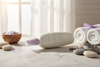 Mary Kay TimeWise Visibly Fit Body Lotion bottle in morning sunlight beside spa accessories on white marble