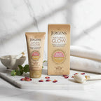 Jergens Natural Glow gold face moisturizer tube and box on soft white marble vanity, delicate morning light lifestyle photography