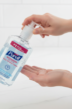 Professional dispensing Purell Advanced 12oz hand sanitizer gel onto palm — More4less Outlet