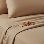 Close-up of soft natural tan polyester bed sheets with sandalwood chips resting on the pillow, warm earthy tones.