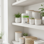White Herbalife Nutrition Personalized Protein Powder tub on a white wooden shelf in a bright minimalist home wellness pantry corner with small green plants and clean white jars.