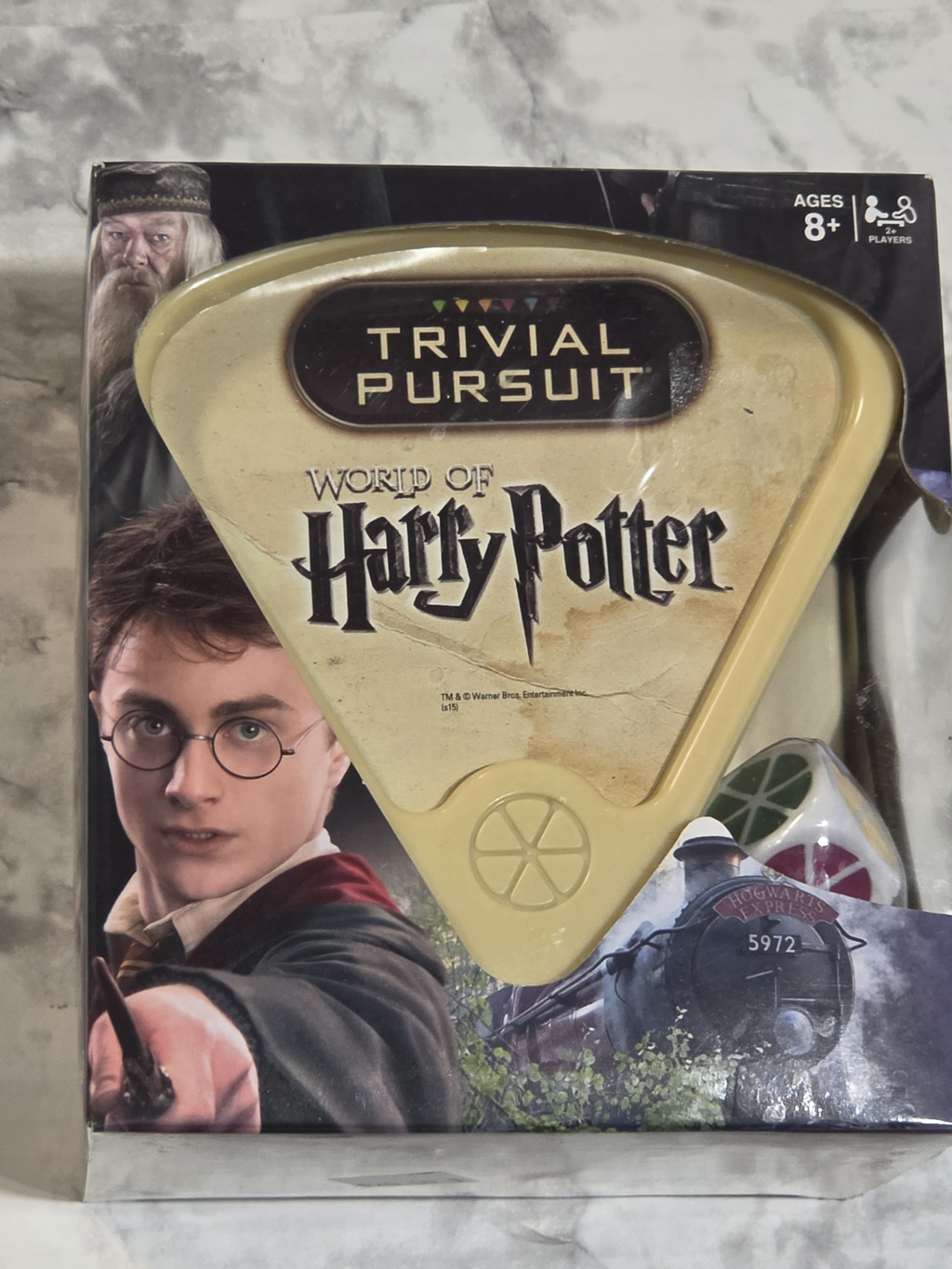 Trivial Pursuit World of Harry Potter game box on a marble surface