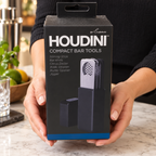 Houdini compact bar tools retail box in held setting; AI-generated lifestyle scene