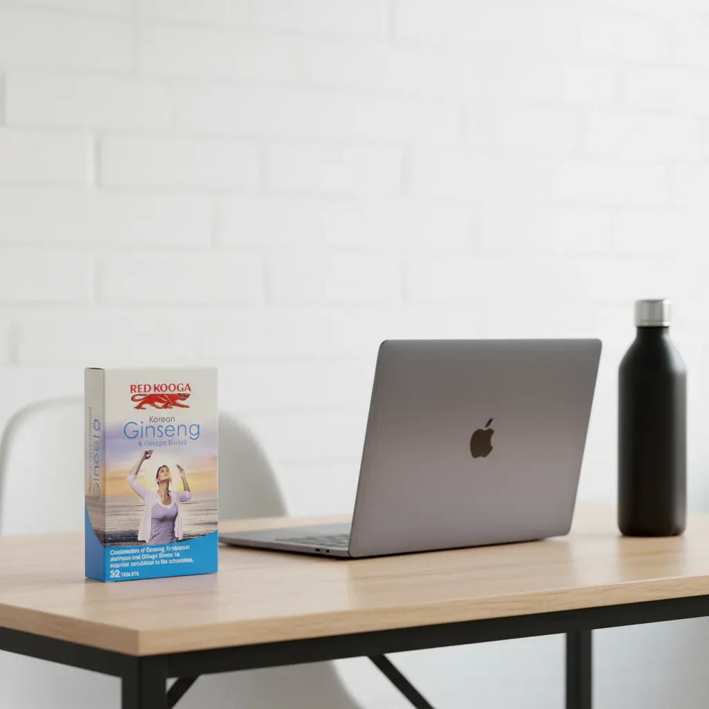 Red Kooga Korean Ginseng Ginkgo Biloba box on minimalist home office desk with dark gray laptop and black matte water bottle