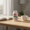 Jarrow Formulas MagMind supplement bottle on wooden desk with open book and green tea – brain health cognitive wellness lifestyle