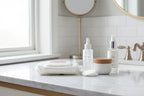 Clean bright vanity setup featuring Rodan + Fields makeup remover wipes alongside skincare basics on marble surface
