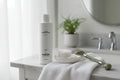 Jan Marini C-ESTA Cleansing Gel on marble vanity with cotton rounds and jade roller lifestyle