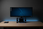Minimalist workstation setup with a 2.1 channel computer speaker system featuring integrated blue LED accent lighting