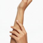 Close-up of smooth, glowing, well-moisturized skin on a woman's forearm and hand