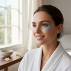 Woman smiling with bright refreshed eyes after a skincare routine in natural window light