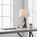 Minimalist concrete desk setup featuring a stone gray geometric twisted lamp base in modern home office