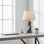 Minimalist concrete desk setup featuring a stone gray geometric twisted lamp base in modern home office