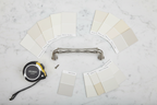Baldwin Couture satin nickel cabinet pull flatlay on white marble with paint swatches and tape measure - More4less Outlet