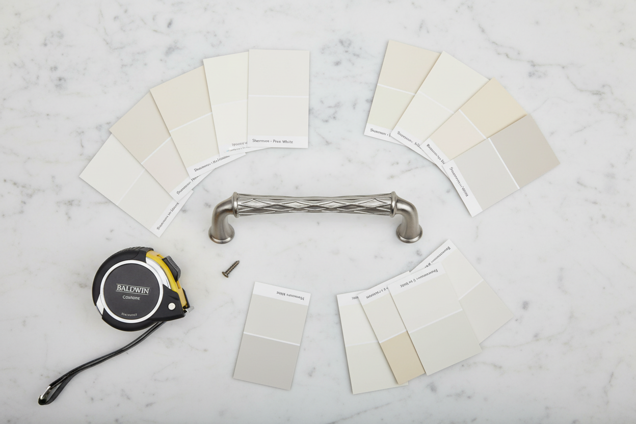 Baldwin Couture satin nickel cabinet pull flatlay on white marble with paint swatches and tape measure - More4less Outlet