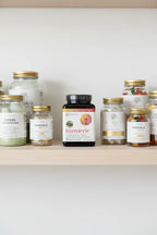 Youtheory Turmeric Extra Strength in organized home wellness pantry shelf with glass supplement containers