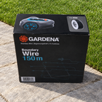GARDENA Boundary Wire 150 m box on a patio beside a green lawn