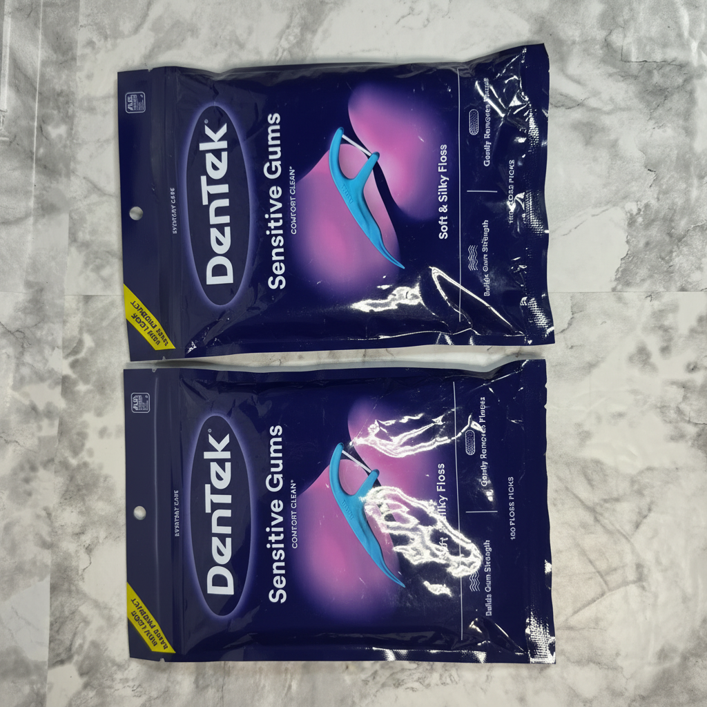 Two sealed DenTek Sensitive Gums Comfort Clean floss pick bags in a flat lay